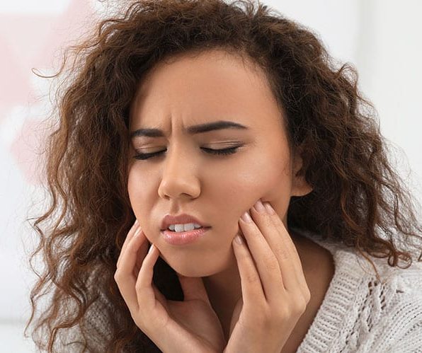 young woman with oral pain